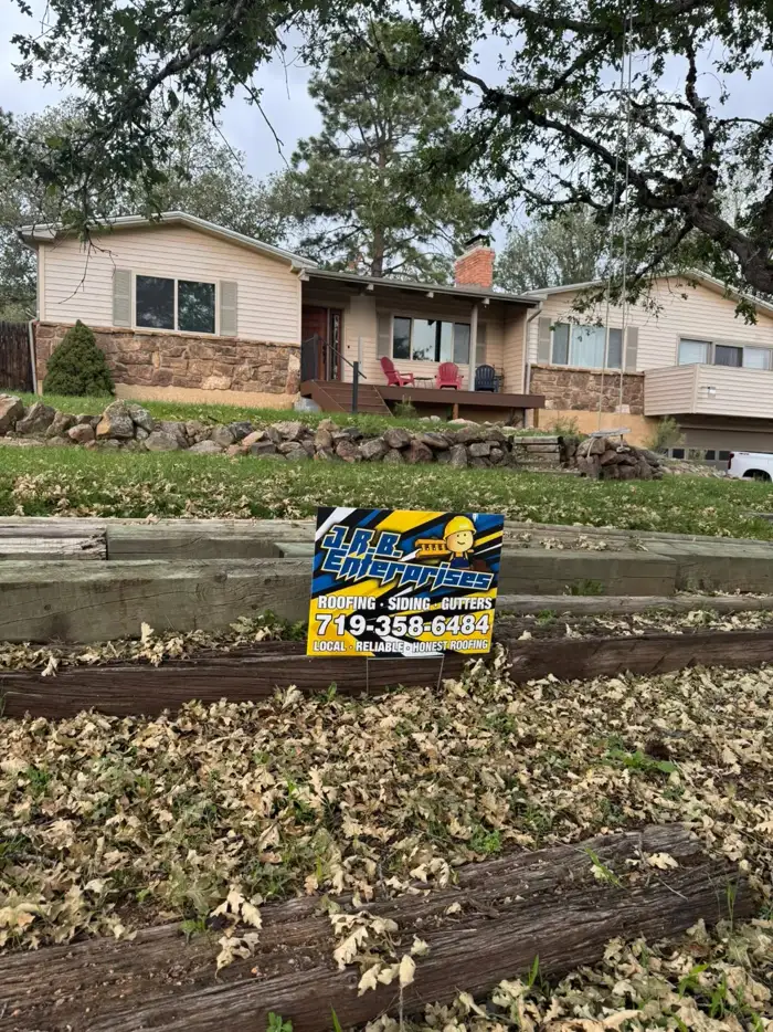 J.R.B. yard sign in front of a home under the oaks