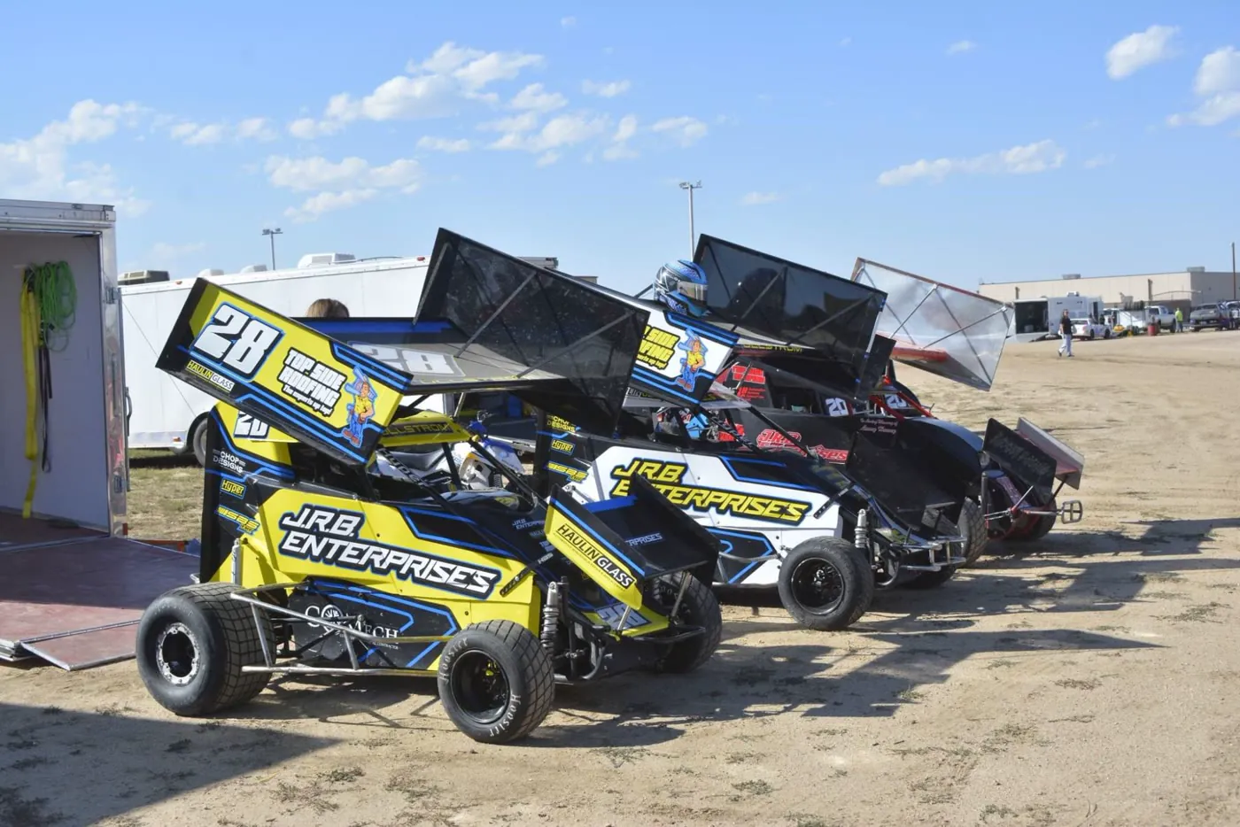 Race cars in J.R.B. Enterprises colors lined up at the track